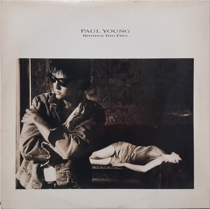 PAUL YOUNG / BETWEEN TWO FIRES